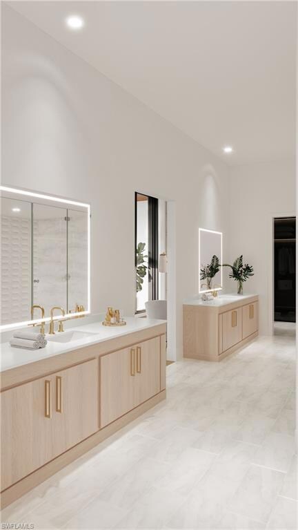 Bathroom featuring vanity and a shower with shower