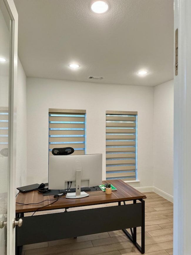 Office space featuring recessed lighting and light wood-type flooring