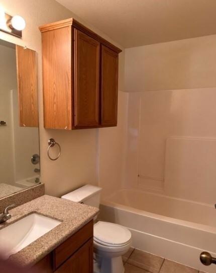 Bathroom featuring vanity, tile patterned floors,
