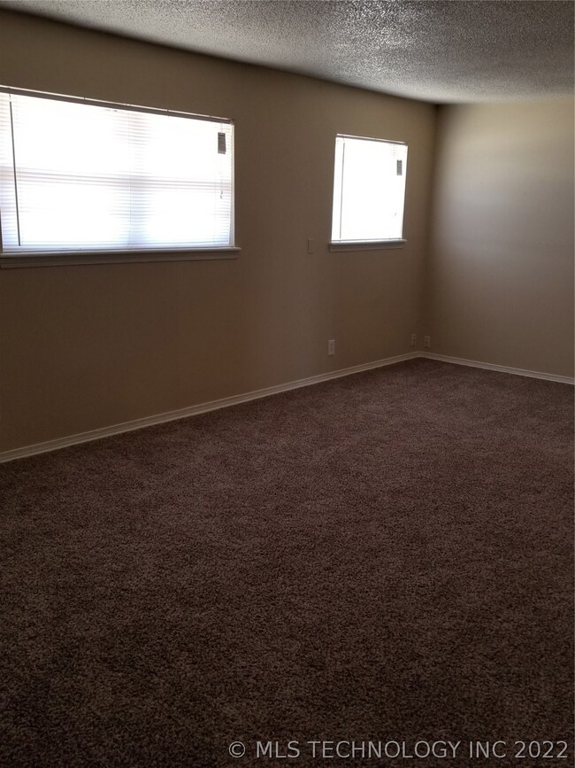 Large Living with new carpet, paint and blinds.
