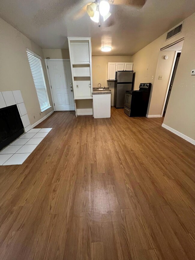 Unfurnished living room featuring a textured ceil