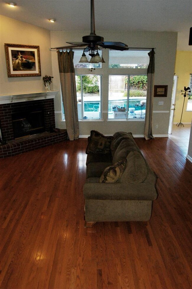 Great room with fireplace over looking backyard po