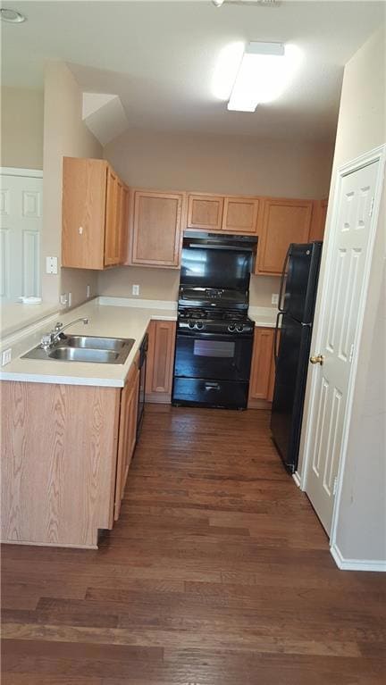 Kitchen featuring black appliances, a sink, exhau