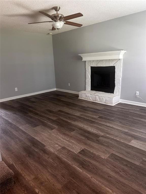Unfurnished living room featuring a stone fireplac
