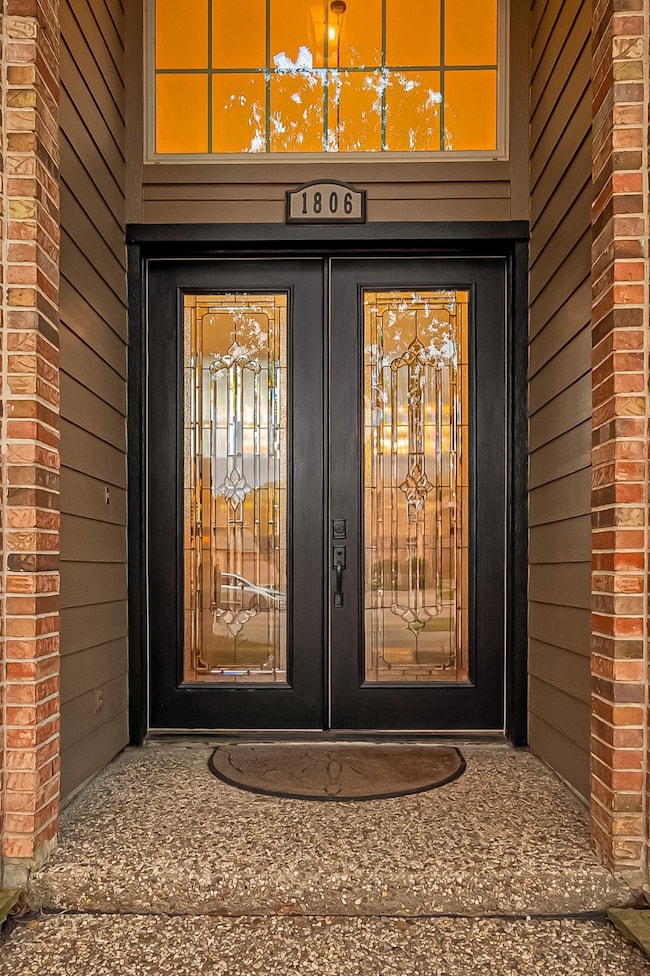 Palacial style double leaded glass doors greet you
