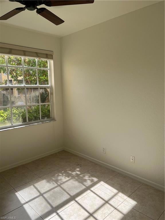 Bedroom room featuring light tile patterned floors and a ceiling fan