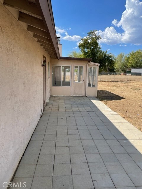 back of house with private sun room.