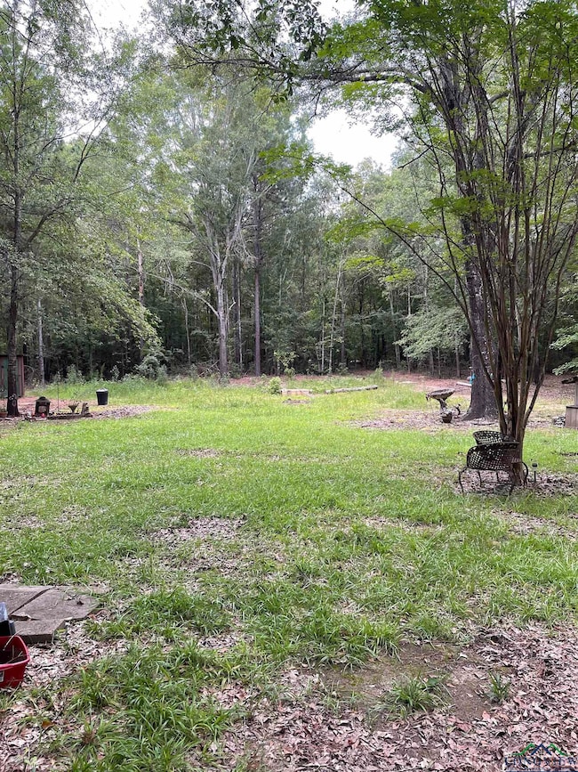 View of yard featuring a wooded view