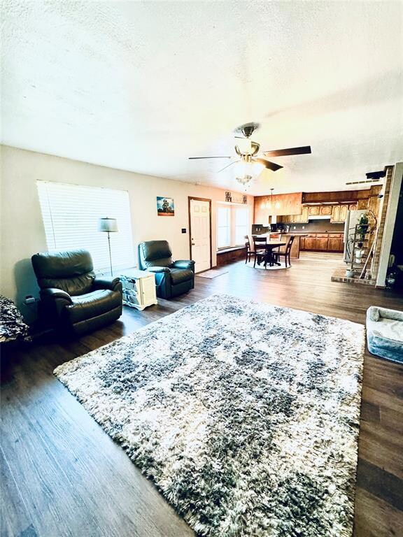 Living room featuring a textured ceiling, dark har