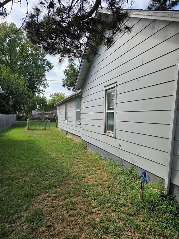 View of property exterior featuring a yard