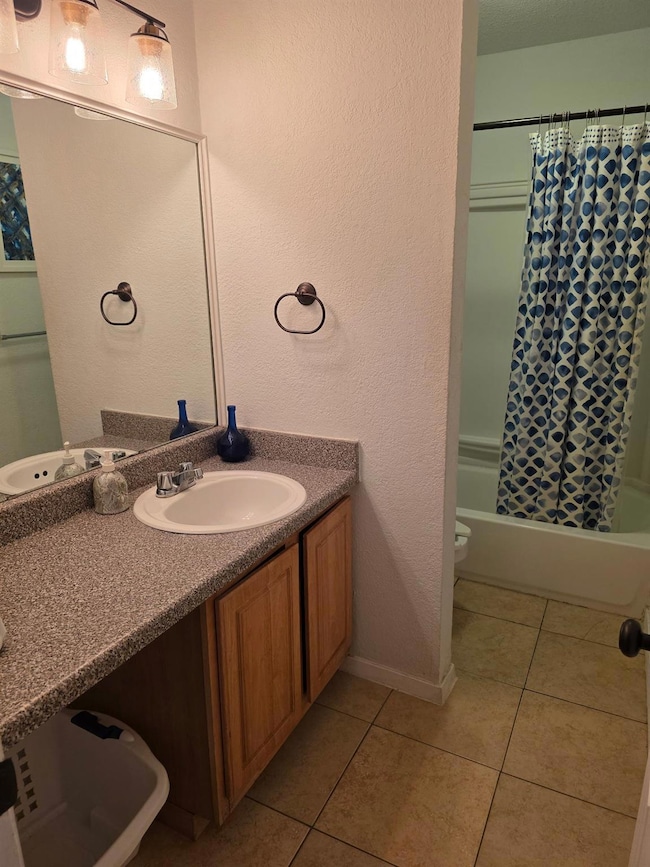 Bathroom featuring vanity, shower / bath combo wi