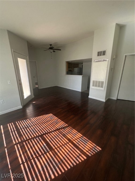 Unfurnished living room featuring wood-type floori