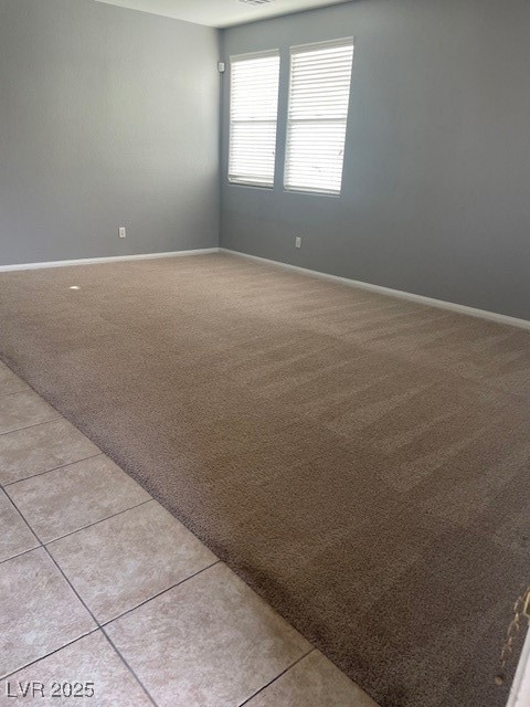 Unfurnished room featuring light colored carpet, l