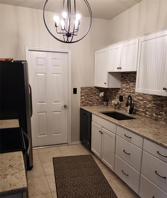 Kitchen with tasteful backsplash, light tile floor