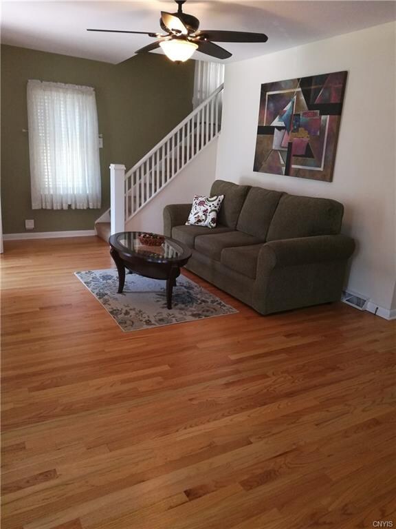 The other side of the living room has an open stai