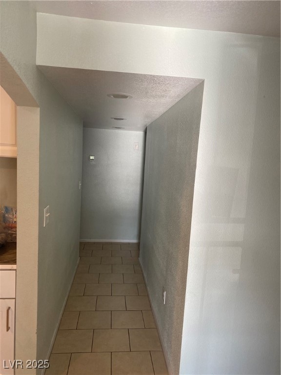 Corridor with baseboards and light tile patterned