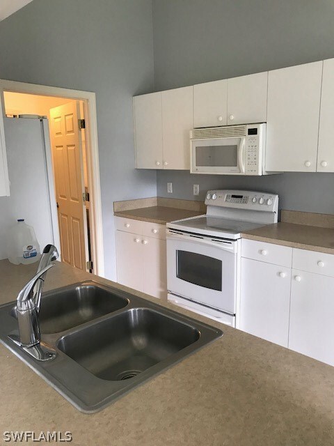 Kitchen w/entry to laundry room and garage.