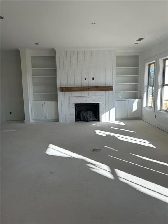 Unfurnished living room featuring built in feature
