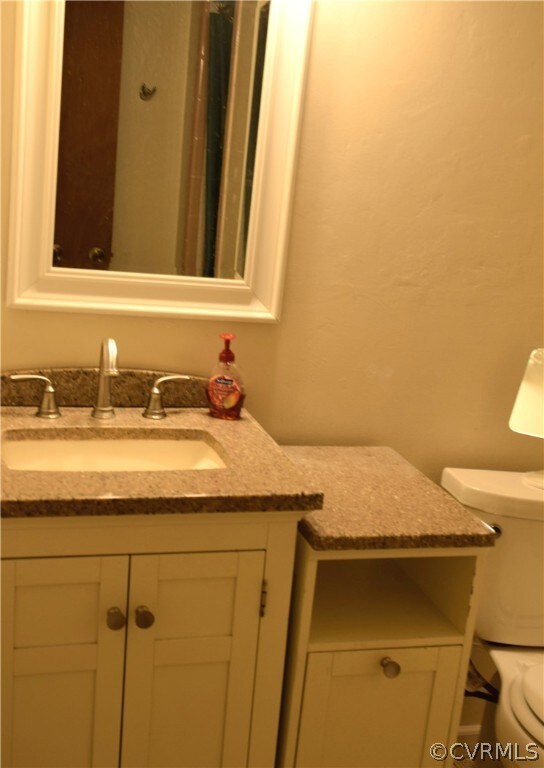 Bathroom featuring vanity and toilet