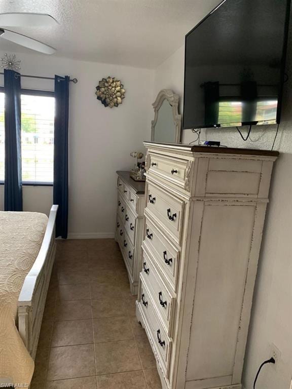 Bedroom featuring light tile patterned flooring and a textured ceiling