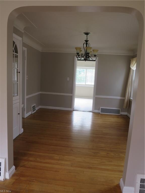 Lovely arched doorway opens to formal dining room 