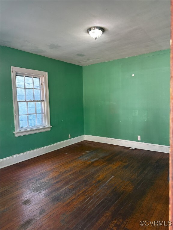 Spare room featuring dark hardwood / wood-style fl