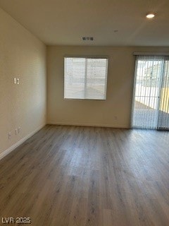 Spare room featuring wood finished floors and recessed lighting