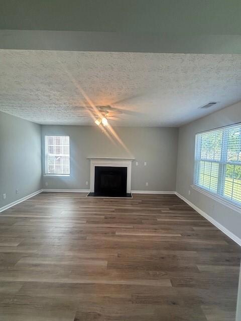 Unfurnished living room with ceiling fan, a firepl