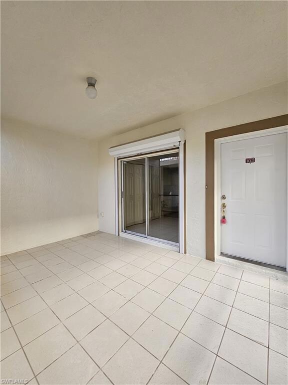 Spare room with light tile patterned floors