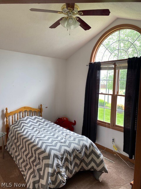 Bedroom two with cathedral ceiling, ceiling fan and carpeting