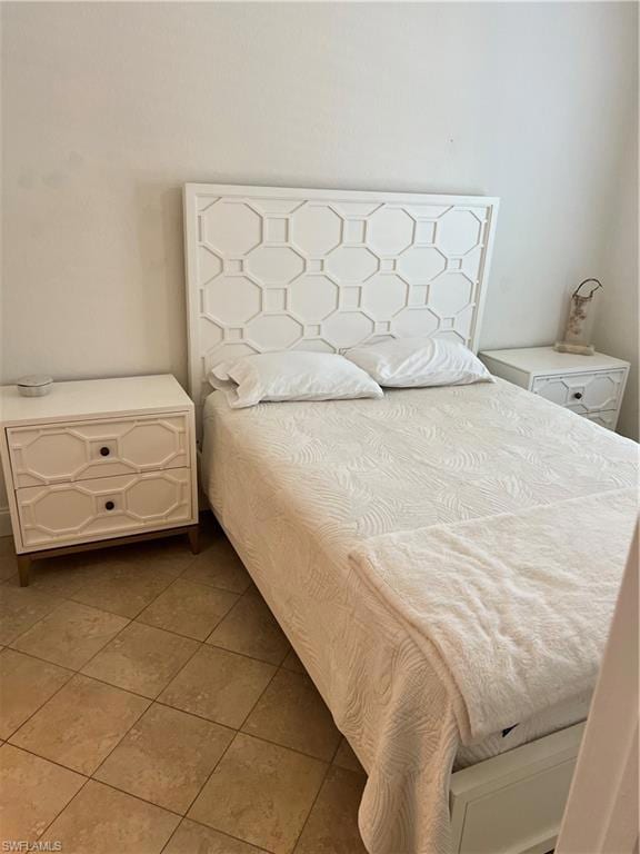 Bedroom with light tile patterned flooring