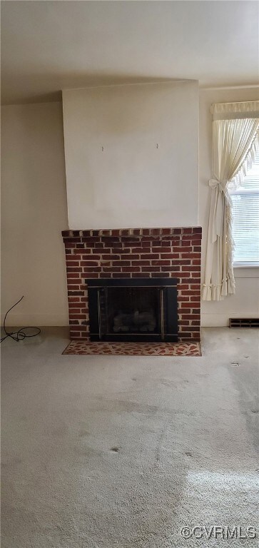 Room details featuring carpet floors and a firepla