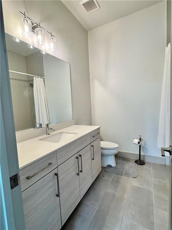 Bathroom with toilet, vanity, curtained shower, an