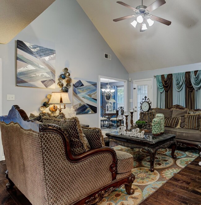 Living room featuring ceiling fan, hardwood / wood