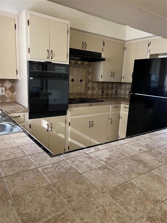 Kitchen with black appliances, under cabinet rang
