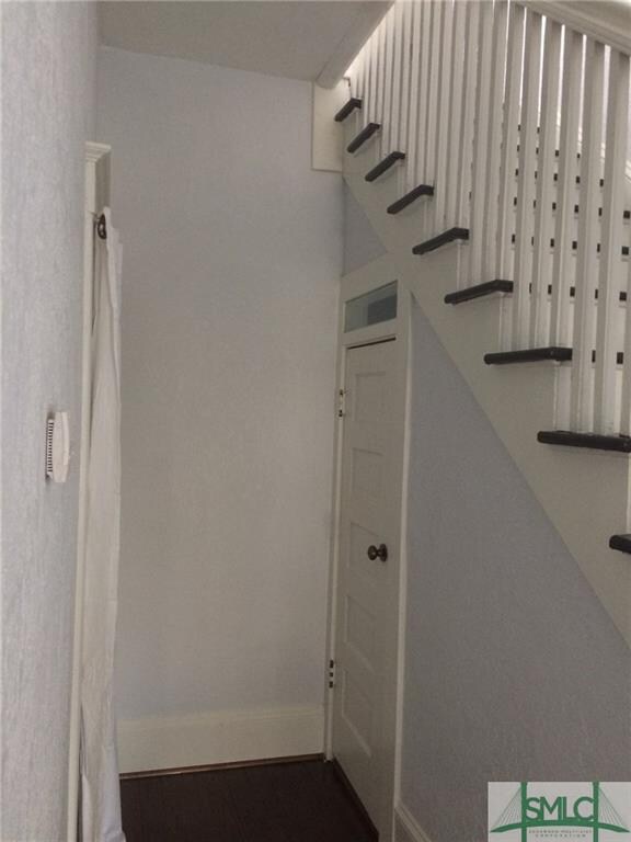 Powder room under stairs at end of front hallway