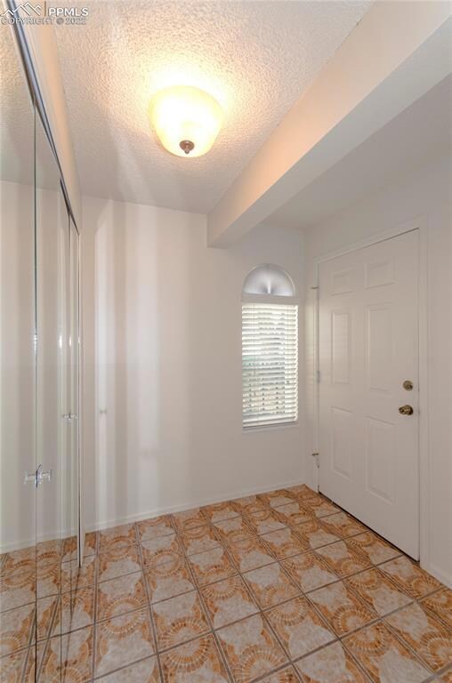 Entry with tiled floor and spacious closet