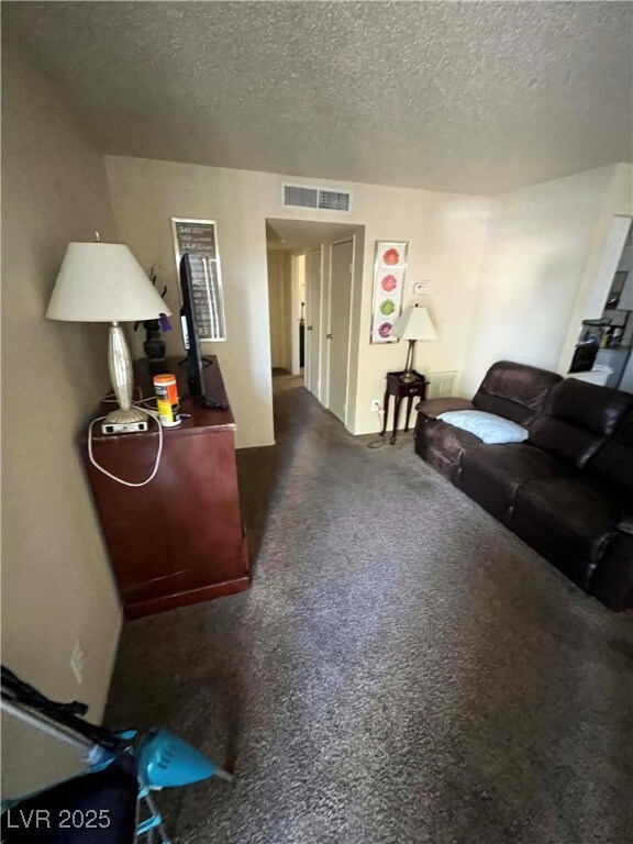 Living area featuring a textured ceiling