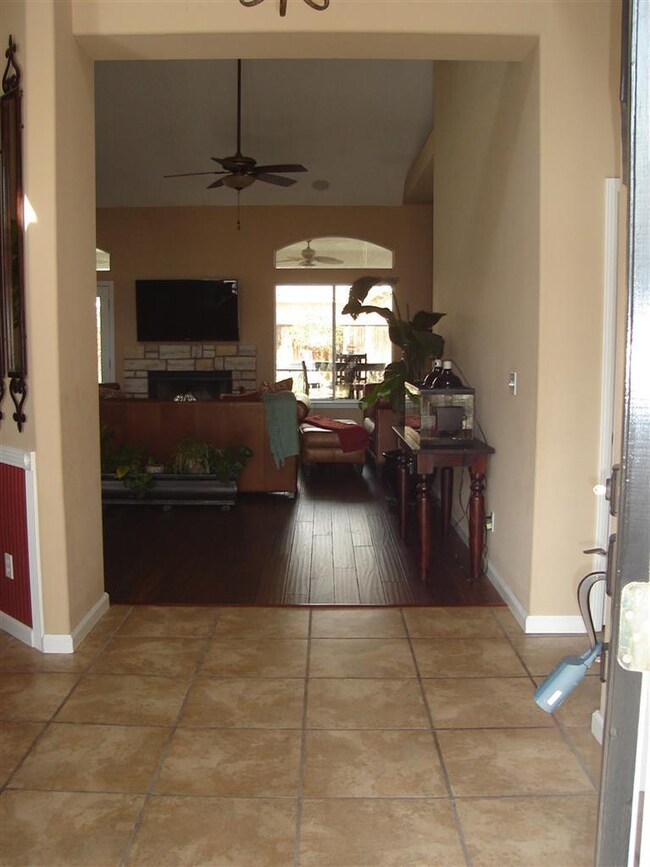 Large vaulted entry foyer with stone look floors o