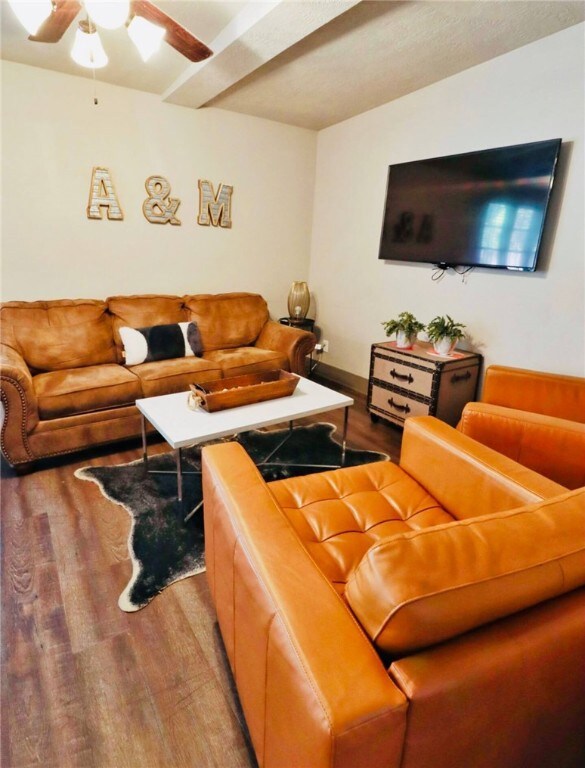 Living area featuring wood finished floors, basebo