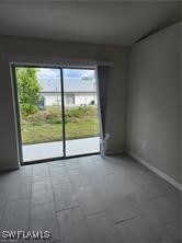 Spare room featuring plenty of natural light and b