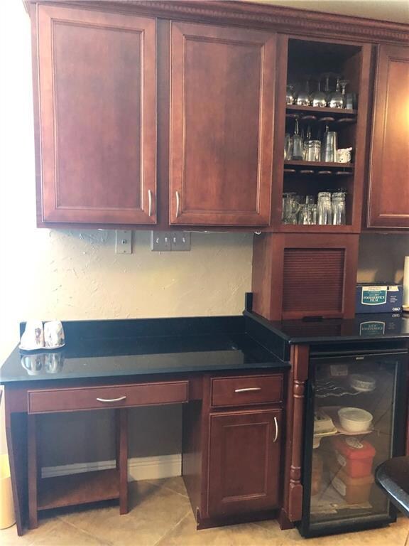 Kitchen has wine cooler with built in desk