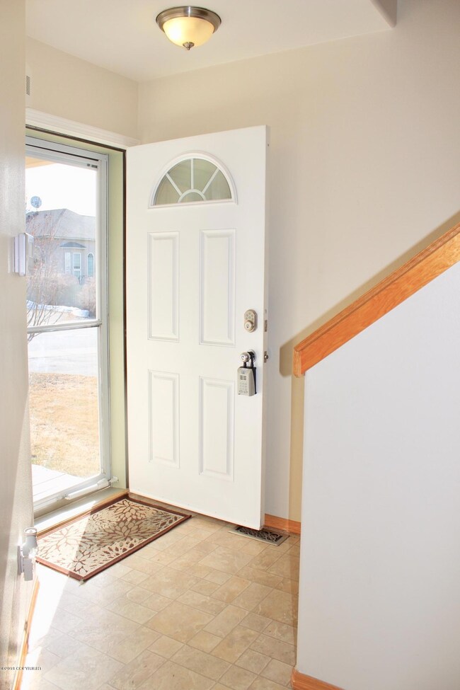 Light and bright foyer with a storm door