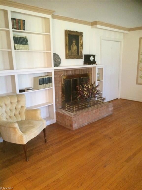 Fireplace with built-in book shelves and raised hearth