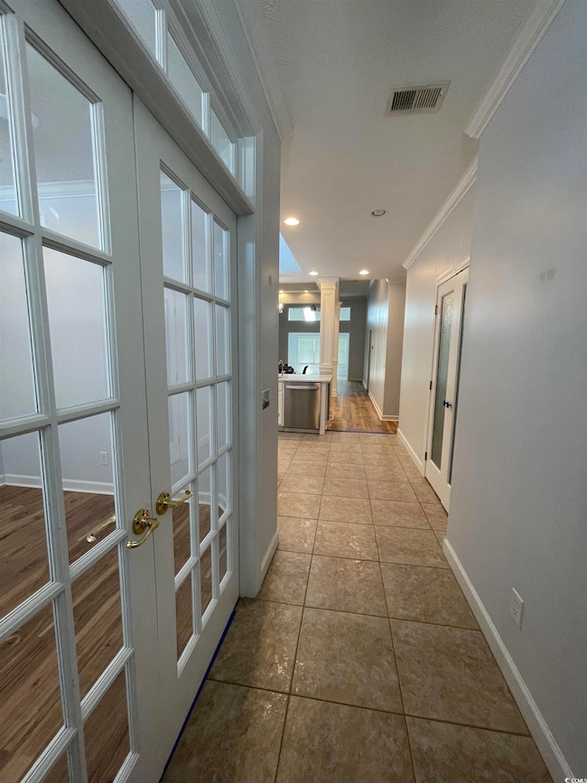 Foyer featuring French Doors to Den, Crown Molding