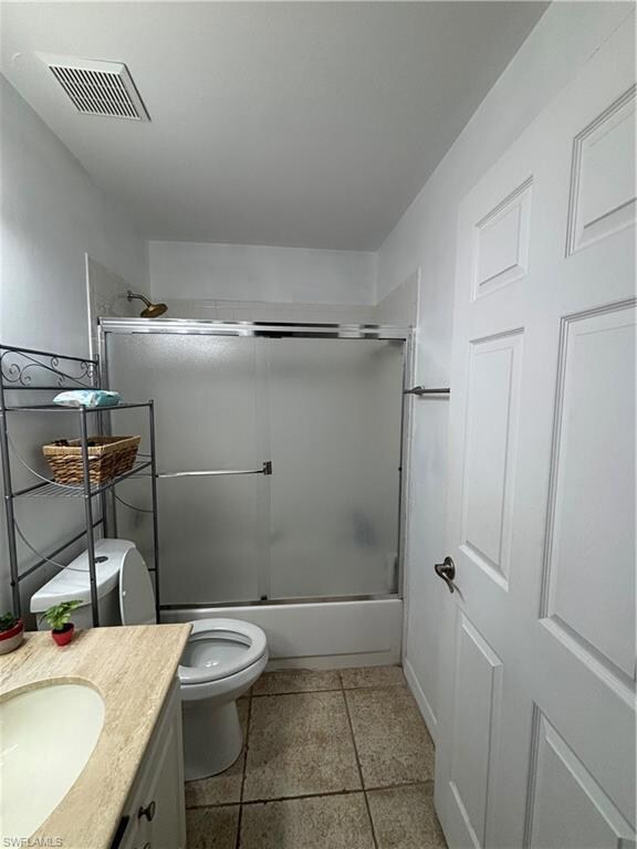 Bathroom featuring toilet, enclosed tub / shower c