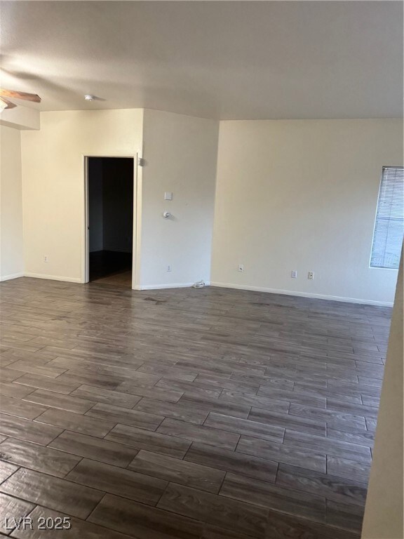 Empty room with wood finish floors, ceiling fan, a