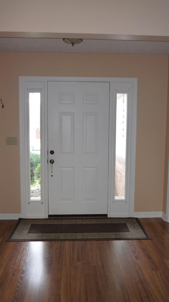 Inviting foyer with updated laminate flooring throughout the downstairs