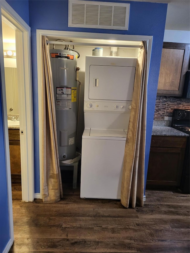 Clothes washing area with dark hardwood / wood-sty