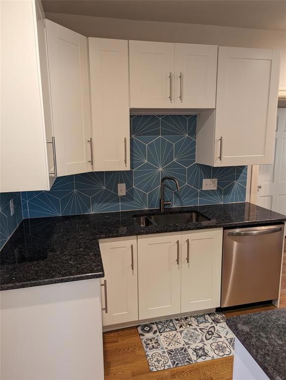 Kitchen with stainless steel dishwasher, a sink, 